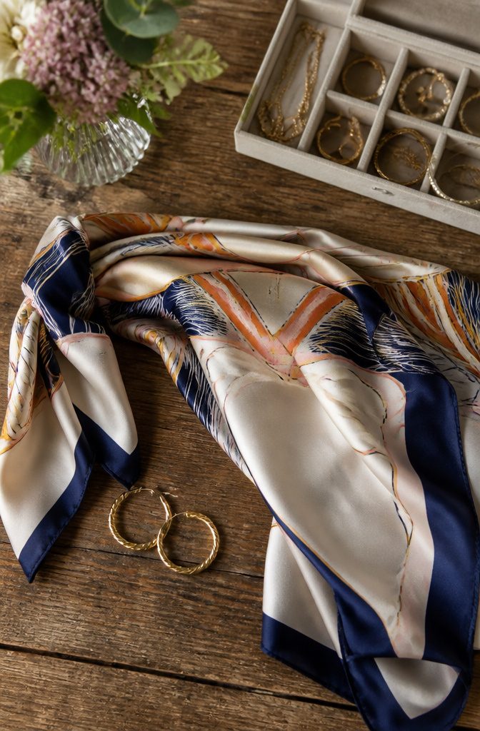 A collection of scarves and jewelry displayed together.