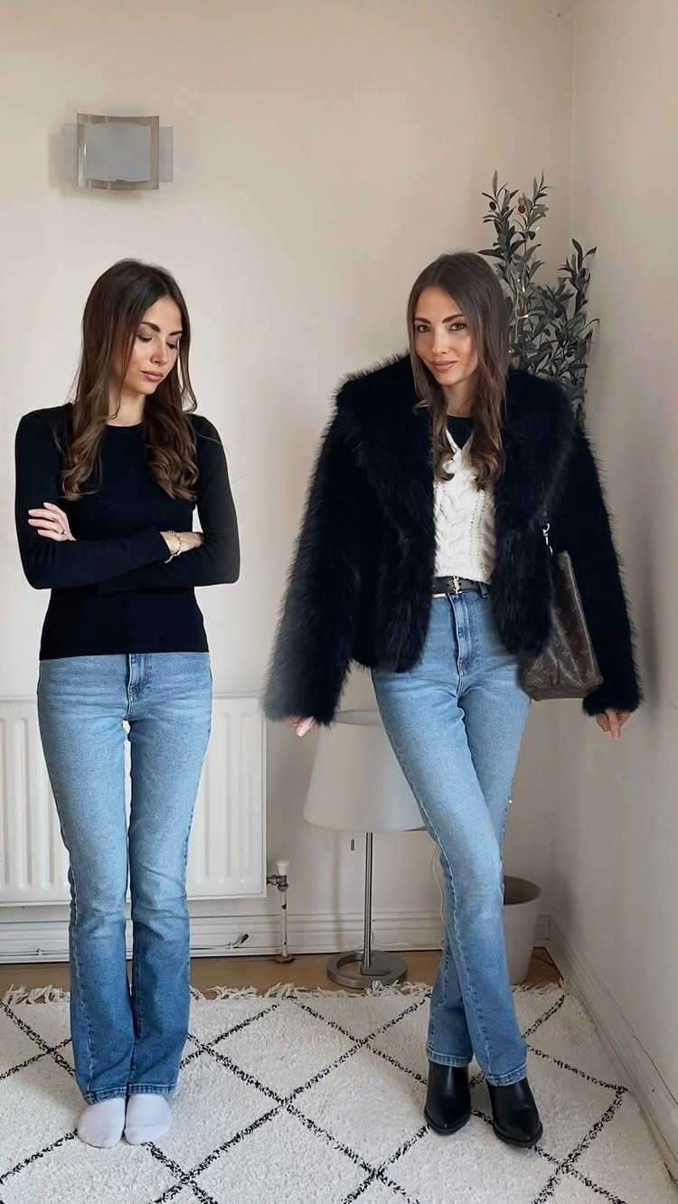 Two women posing in casual holiday outfits consisting of jeans, sweaters, and a faux fur jacket.